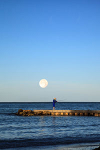 Scenic view of sea against clear blue sky