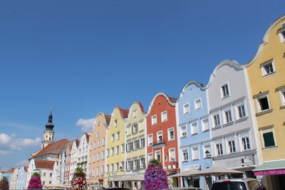 Low angle view of buildings against blue sky