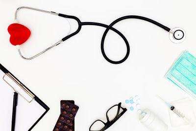 High angle view of eyeglasses on table against white background