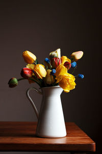 Close-up of vase on table against black background