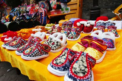 Close-up of various baby booties at market