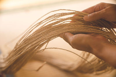 The process of weaving basket bags from fibers of plants native to miyako island, in okinawa japan.