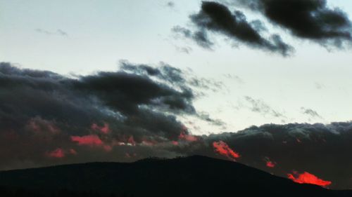 Silhouette landscape against sky