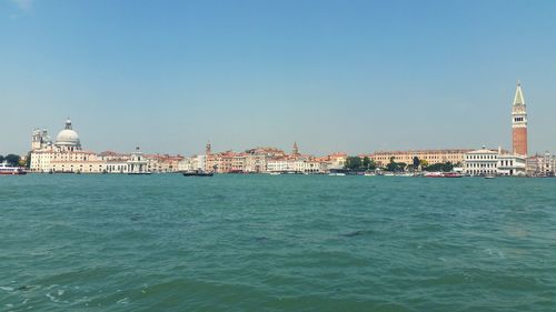 View of buildings at waterfront against sky