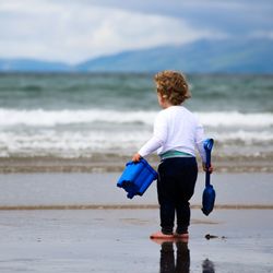 Rear view of woman standing on beach