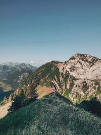 Scenic view of mountains against clear blue sky