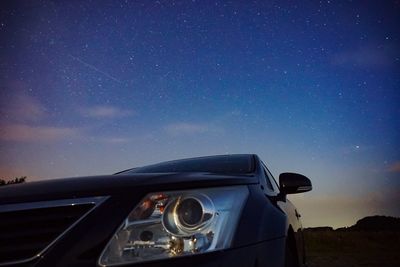 Car against blue sky at night