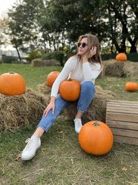 Rear view of woman with pumpkins