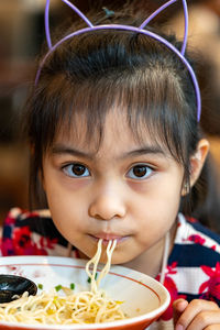 Cute girl eating food at restaurant