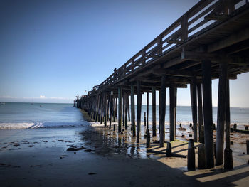 Pier over sea against clear sky