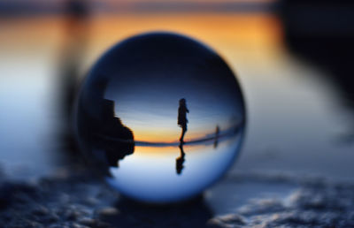 Close-up of crystal ball on beach