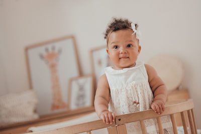 Portrait of cute baby girl at home