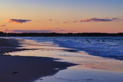 Scenic view of beach against sky during sunset