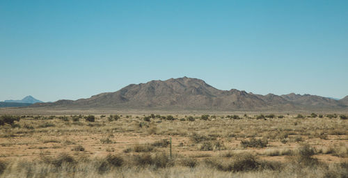 Scenic view of mountains against clear blue sky