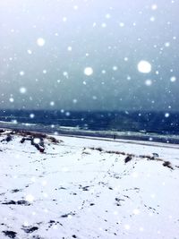 Scenic view of frozen lake against sky at night