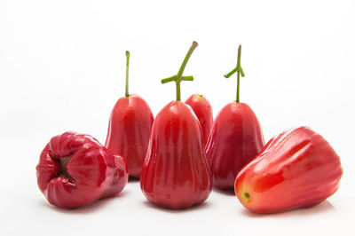 Close-up of red chili over white background