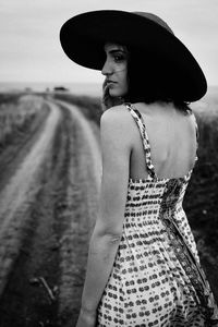 Portrait of woman wearing hat standing on land