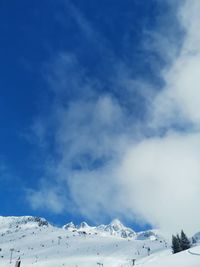 Low angle view of snowcapped mountain against sky