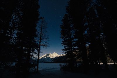 Scenic view of snowcapped mountains against sky at night