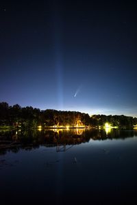 Scenic view of lake against sky at night