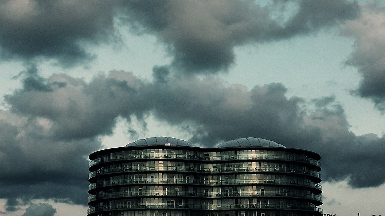 building exterior, architecture, built structure, low angle view, sky, cloud - sky, city, skyscraper, modern, cloudy, tall - high, tower, office building, building, weather, cloud, overcast, outdoors, no people, tall