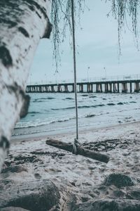 Scenic view of beach against sky during winter