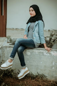 Portrait of young woman sitting outdoors