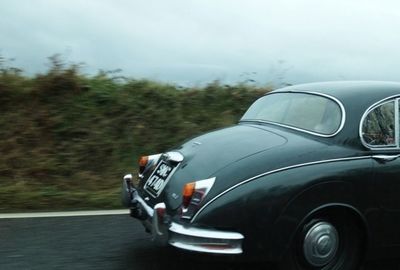 Close-up of cropped car on road