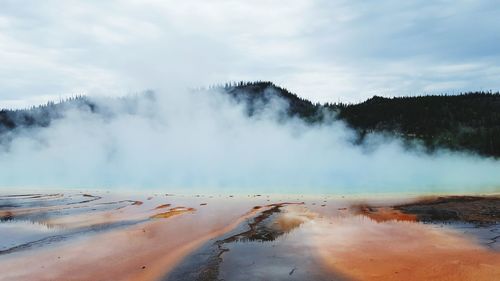 Scenic view of steam emitting from landscape