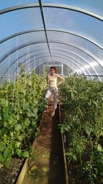Woman standing in greenhouse