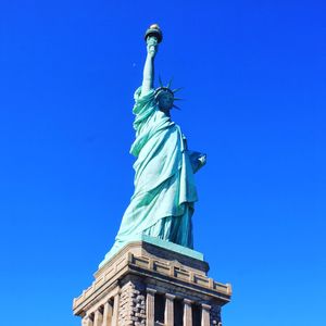 Low angle view of statue against blue sky