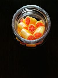 Close-up of orange candies in a jar