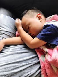 Close-up of boy sleeping on bed at home