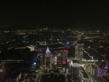 High angle view of city lit up at night