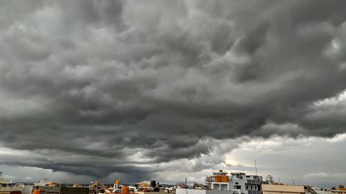 Storm clouds over city buildings