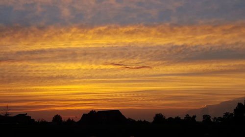 Silhouette of built structure against dramatic sky