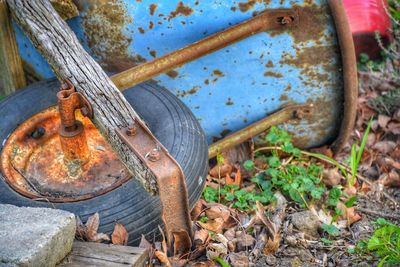 High angle view of old rusty wheel on field