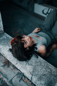 High angle portrait of woman lying on floor