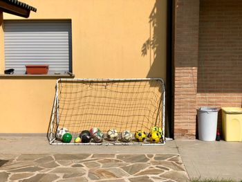 Football balls and score against building