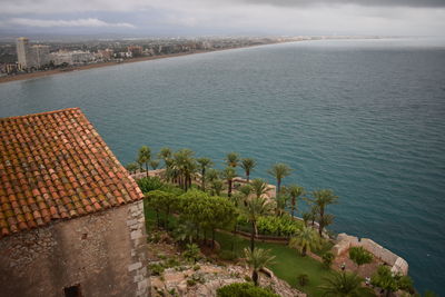 High angle view of buildings by sea against sky