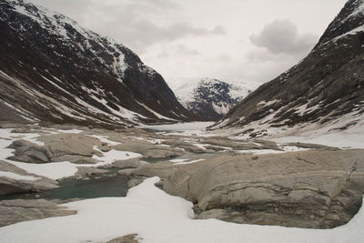 Glacier landscape with ice and rocks in norway, illustrating retreating ice due to climate change. 