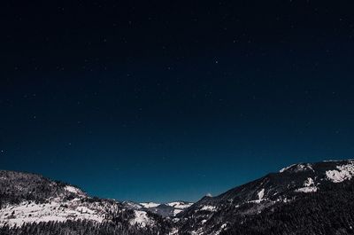 Low angle view of mountain against clear sky at night