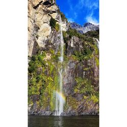 Scenic view of waterfall against sky