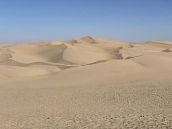 Scenic view of desert against clear sky