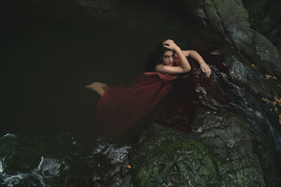 High angle portrait of beautiful woman posing in water