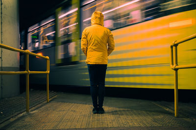 Rear view of man walking in subway