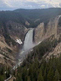 High angle view of waterfall amidst mountains