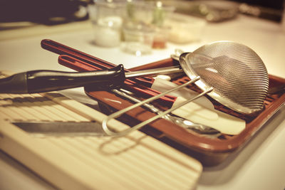 Close-up of kitchen utensils in tray on table