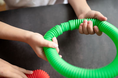 Anti stress sensory pop tube toys in a children's hands. a little kids plays with a poptube toy