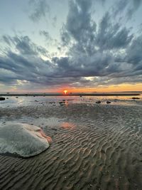 Scenic view of beach against sky during sunset